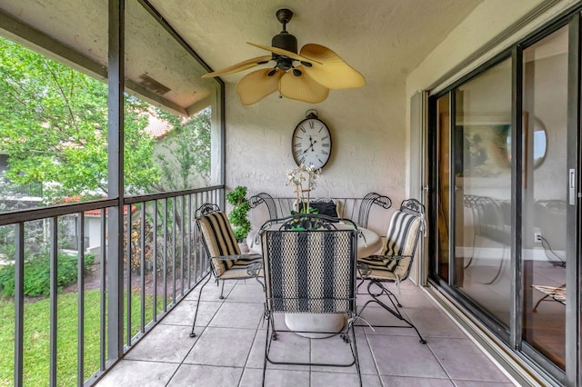 sunroom / solarium with lofted ceiling and ceiling fan