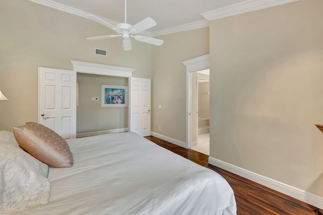 bedroom with wood-type flooring, ceiling fan, ensuite bathroom, and crown molding