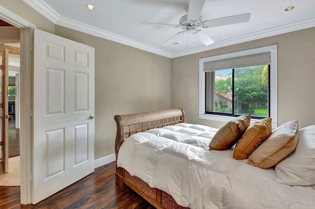 bedroom with ceiling fan, ornamental molding, and dark wood-type flooring