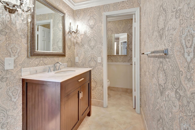 bathroom with ornamental molding, vanity, toilet, and tile patterned floors