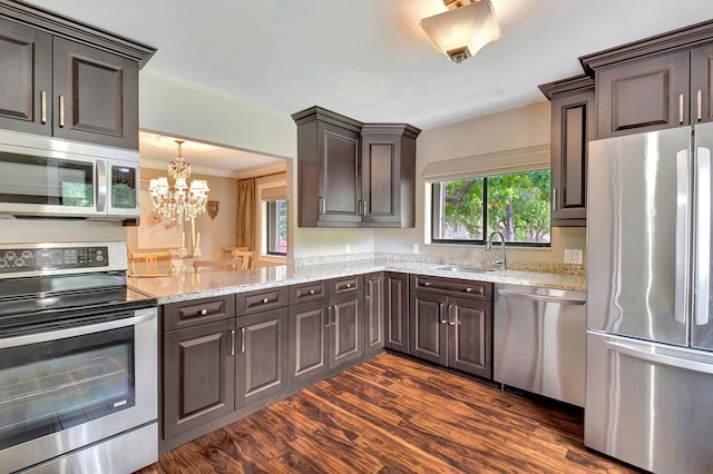 kitchen with dark wood-type flooring, stainless steel appliances, dark brown cabinetry, ornamental molding, and sink