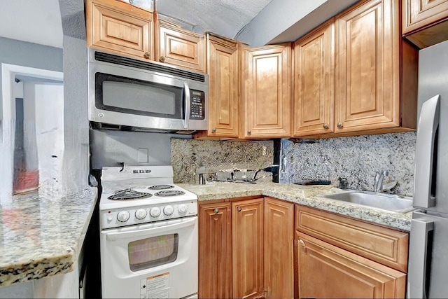 kitchen featuring decorative backsplash, appliances with stainless steel finishes, and sink