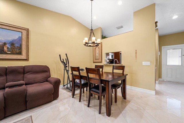 dining room with a notable chandelier and vaulted ceiling