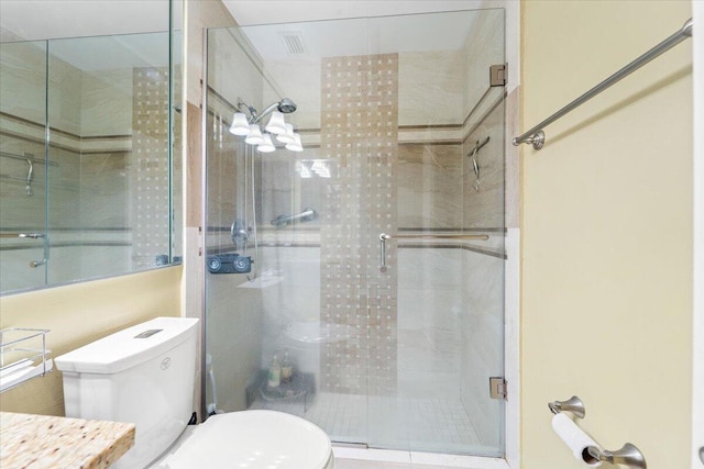 bathroom featuring toilet and an enclosed shower