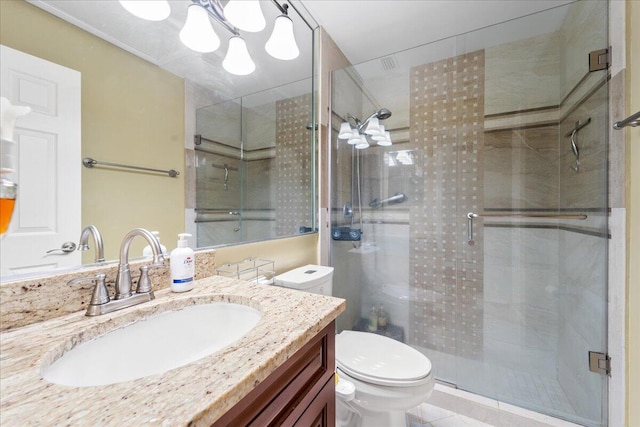 bathroom featuring tile patterned floors, a shower with door, vanity, and toilet