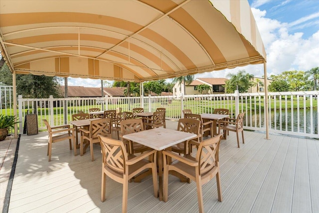 wooden deck featuring a yard and a water view