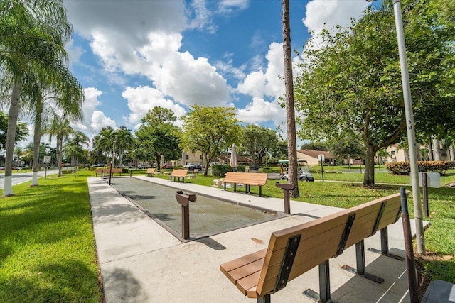 view of property's community with a lawn