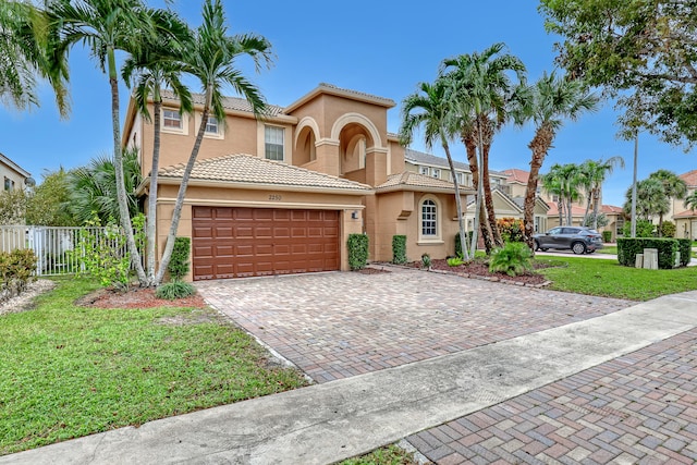 mediterranean / spanish-style house featuring a front lawn