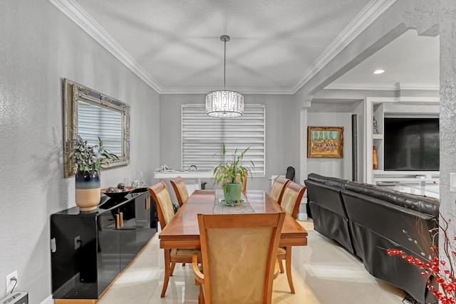 tiled dining space featuring an inviting chandelier, ornamental molding, and a textured ceiling