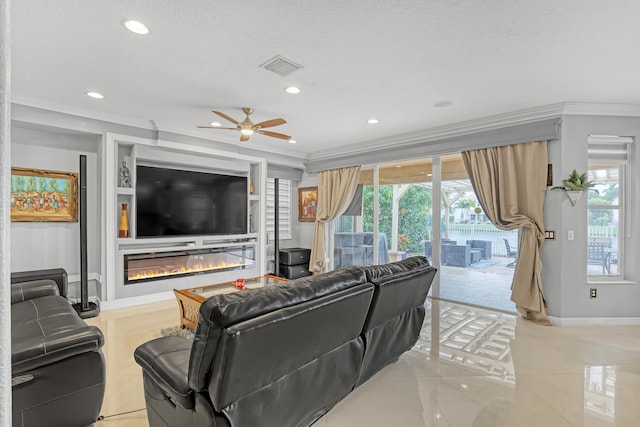 living room featuring crown molding, a textured ceiling, a healthy amount of sunlight, and ceiling fan