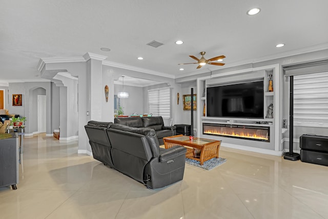 tiled living room with crown molding and ceiling fan with notable chandelier