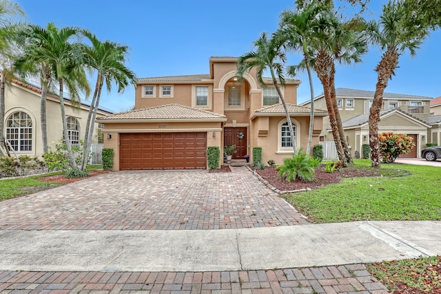 mediterranean / spanish-style house with a front yard and a garage