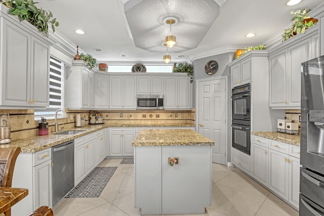 kitchen with a wealth of natural light, pendant lighting, a center island, and stainless steel appliances