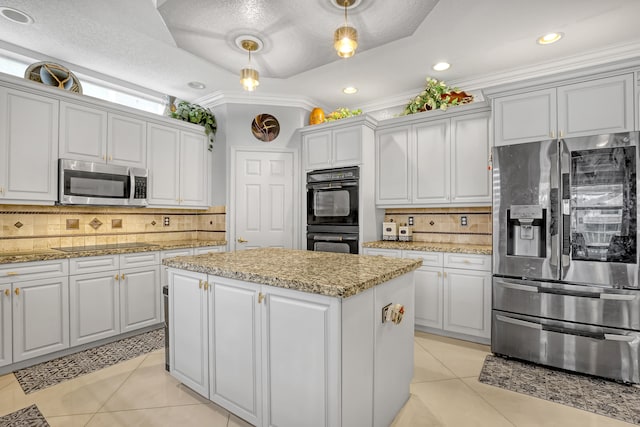 kitchen featuring black appliances, decorative light fixtures, decorative backsplash, and ornamental molding