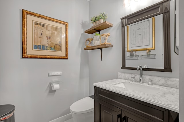 bathroom featuring toilet and vanity