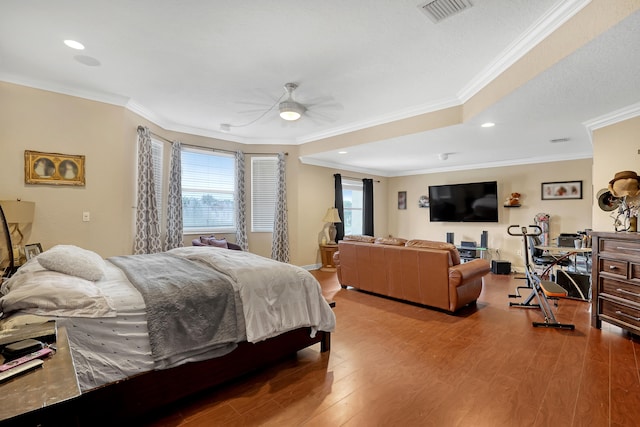 bedroom with ornamental molding, wood-type flooring, and ceiling fan