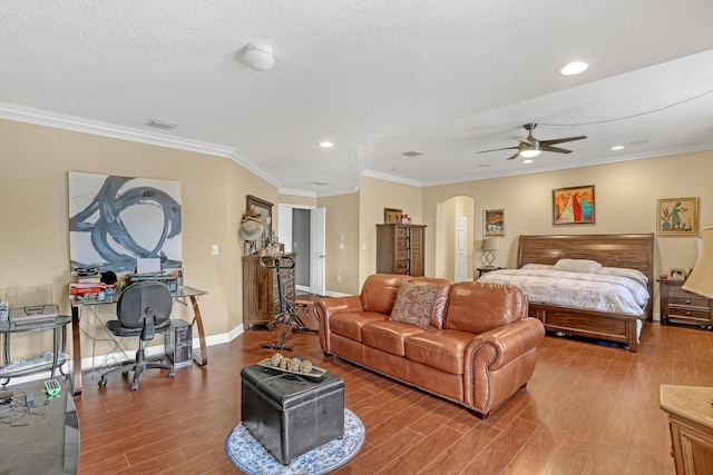 bedroom with crown molding, hardwood / wood-style floors, and ceiling fan