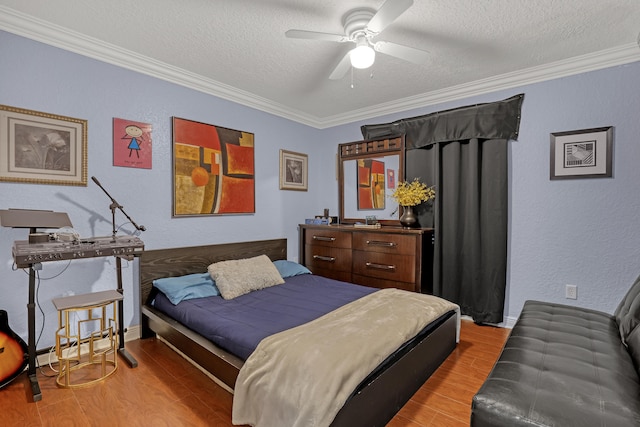 bedroom featuring ceiling fan, crown molding, a textured ceiling, and light wood-type flooring