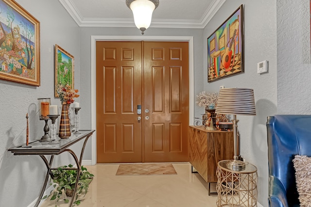 tiled foyer entrance featuring ornamental molding