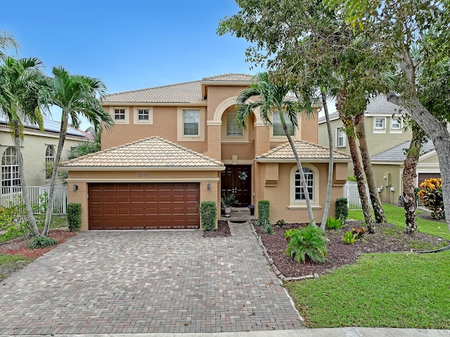 mediterranean / spanish-style home with a front yard