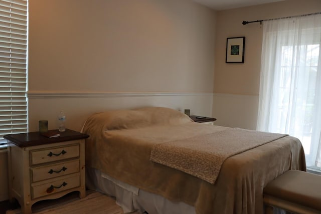 bedroom with wood-type flooring and multiple windows