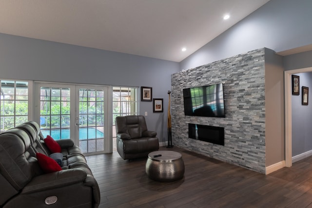 living room with french doors, high vaulted ceiling, dark wood-type flooring, and a fireplace