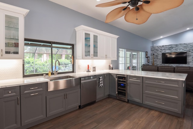 kitchen with dark hardwood / wood-style flooring, white cabinetry, vaulted ceiling, dishwasher, and gray cabinets