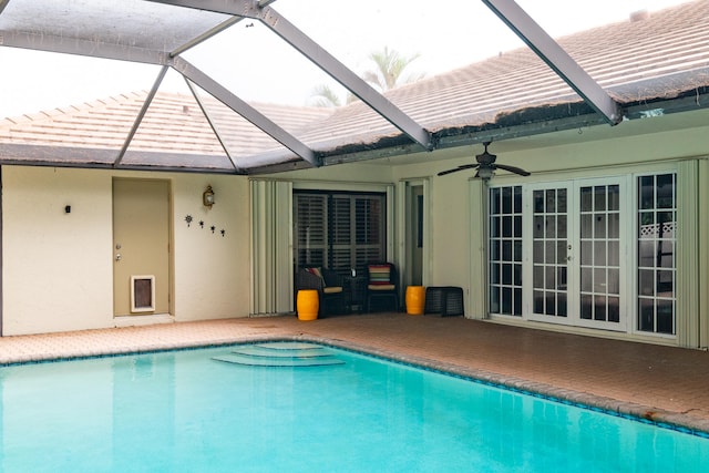 view of pool with a patio, ceiling fan, a lanai, and french doors