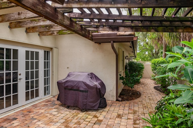 view of patio / terrace featuring french doors, a pergola, and grilling area