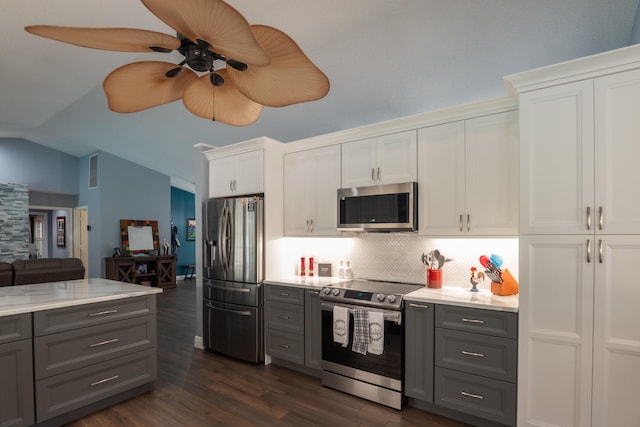 kitchen with lofted ceiling, white cabinetry, dark wood-type flooring, gray cabinets, and stainless steel appliances