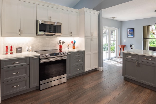 kitchen featuring appliances with stainless steel finishes, white cabinetry, gray cabinets, and dark hardwood / wood-style floors