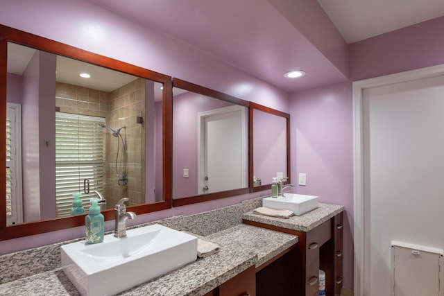 bathroom featuring vanity and a tile shower