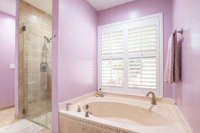 bathroom with tile patterned floors and shower with separate bathtub