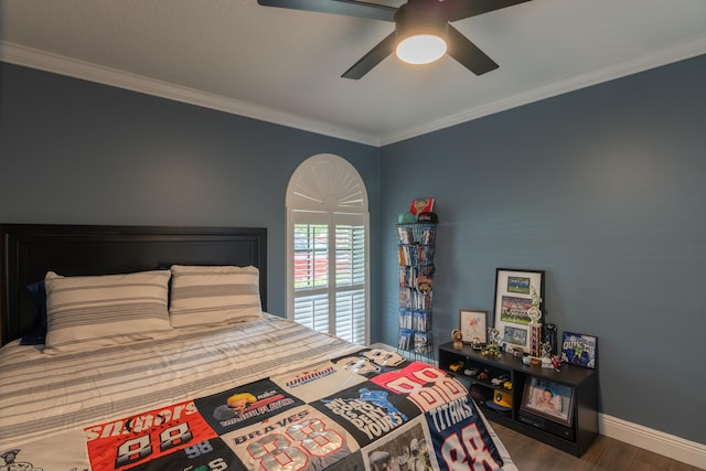 bedroom featuring ceiling fan, ornamental molding, and dark hardwood / wood-style flooring