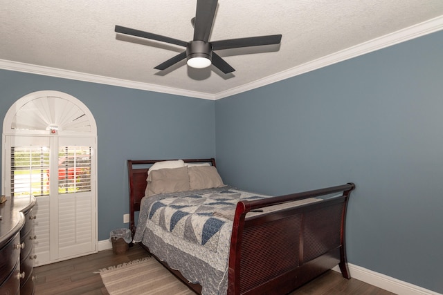 bedroom with dark wood-type flooring, crown molding, a textured ceiling, and ceiling fan