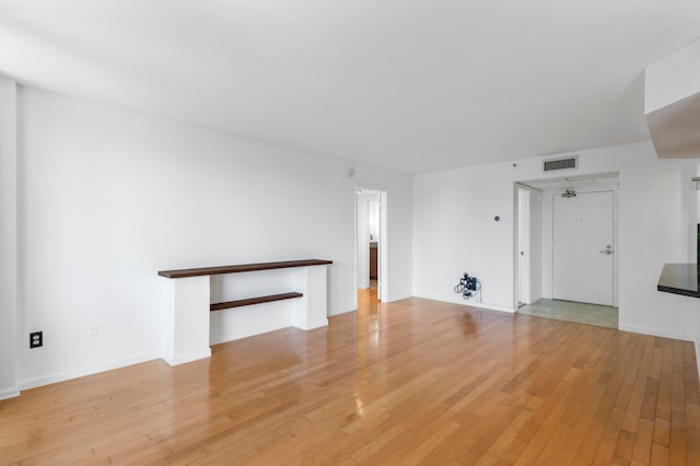 unfurnished living room with light hardwood / wood-style flooring