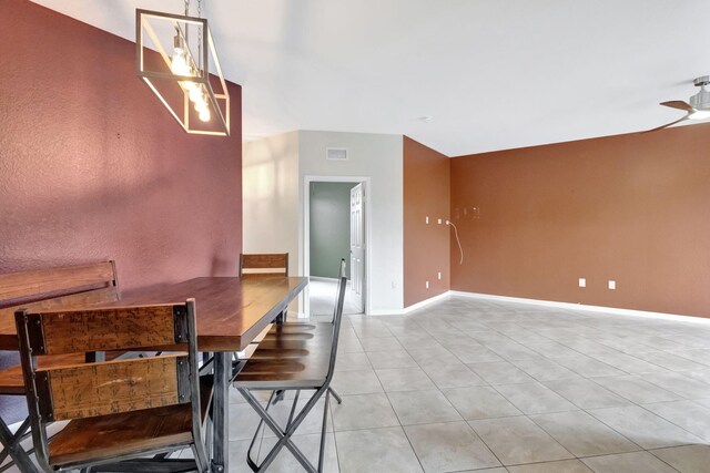 kitchen featuring sink, light tile patterned floors, decorative light fixtures, appliances with stainless steel finishes, and an inviting chandelier