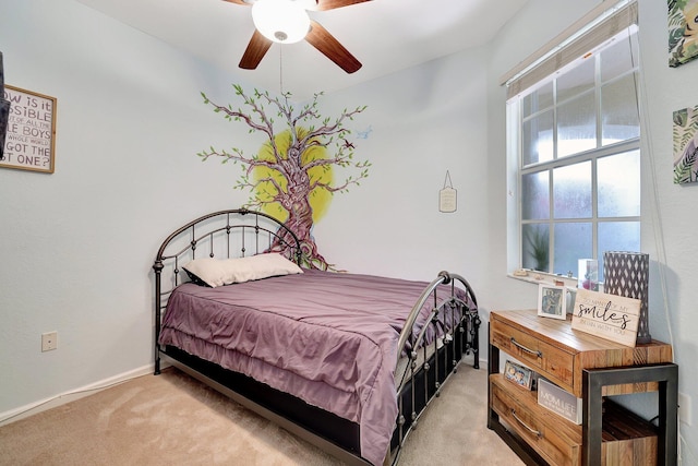 bedroom with ceiling fan and light carpet