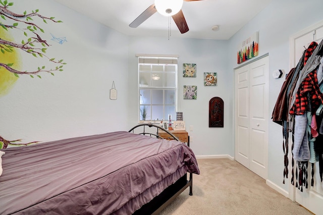 carpeted bedroom with a closet and ceiling fan