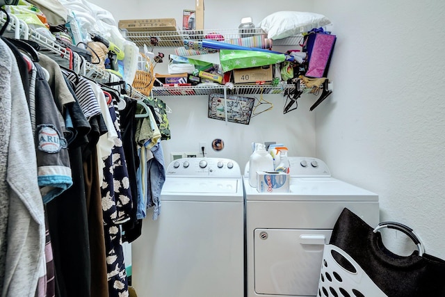 clothes washing area with washer and clothes dryer