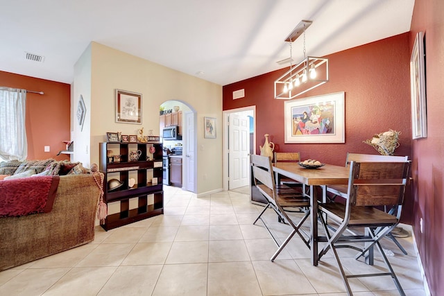 dining room with an inviting chandelier and light tile patterned floors