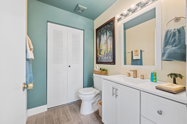 bathroom featuring vanity and toilet