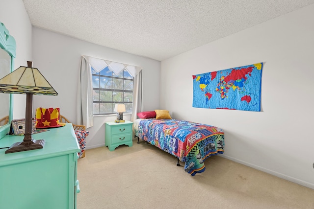 bedroom with light colored carpet and a textured ceiling