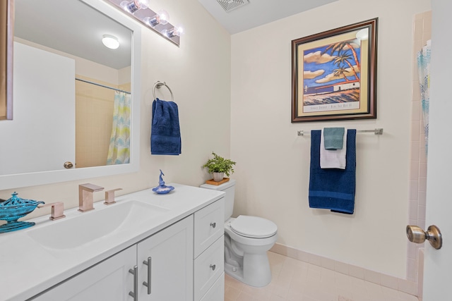 bathroom featuring tile patterned flooring, vanity, curtained shower, and toilet