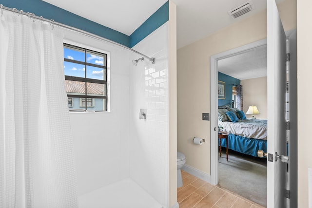 bathroom with toilet and curtained shower