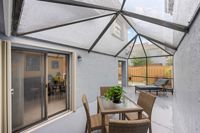 sunroom / solarium with lofted ceiling with beams