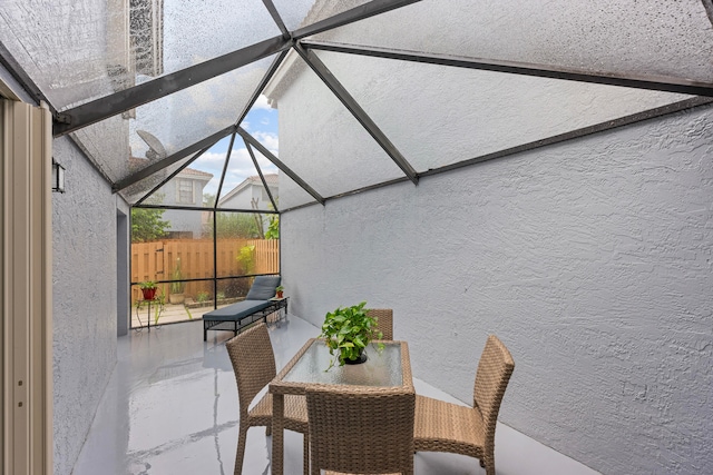 view of patio featuring glass enclosure