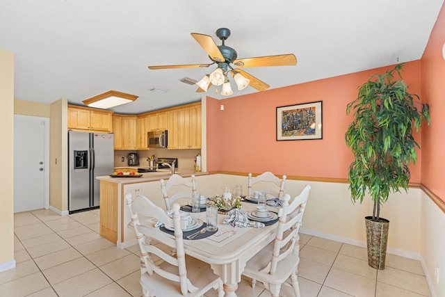 tiled dining room featuring ceiling fan