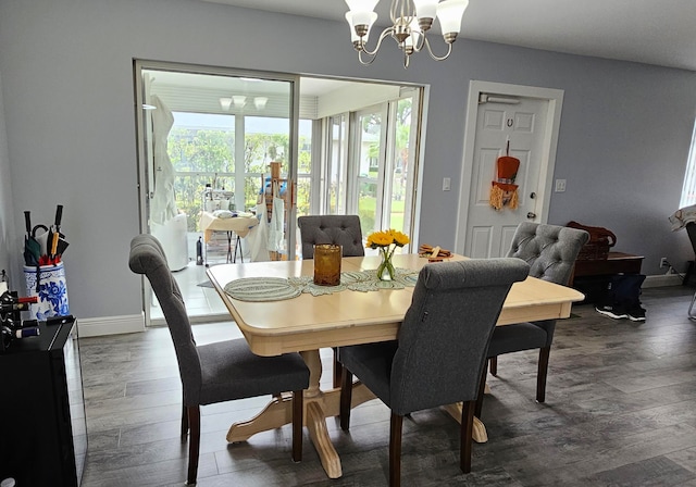 dining room featuring dark hardwood / wood-style floors and a chandelier