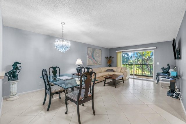 tiled dining area featuring a notable chandelier and a textured ceiling